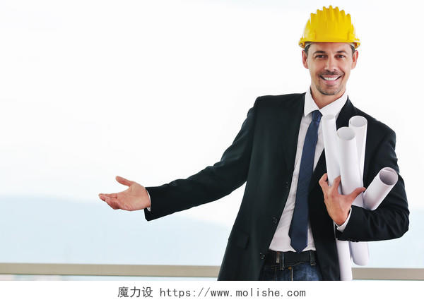 快乐年轻的建筑师头戴头盔拿图纸的国外男建筑师人物图片